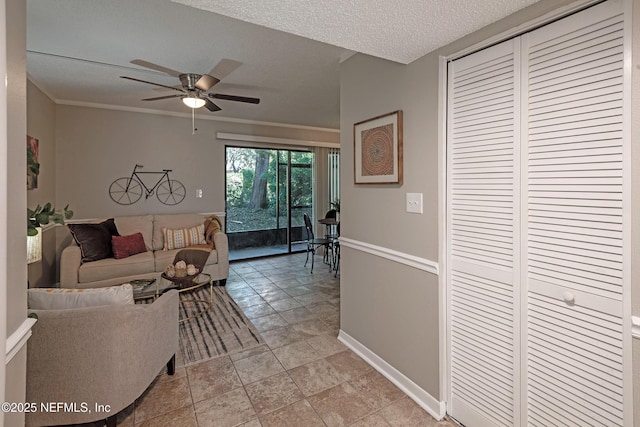 living room featuring a textured ceiling and ceiling fan