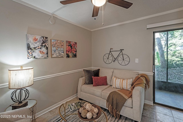 tiled living room with a textured ceiling, ceiling fan, and crown molding