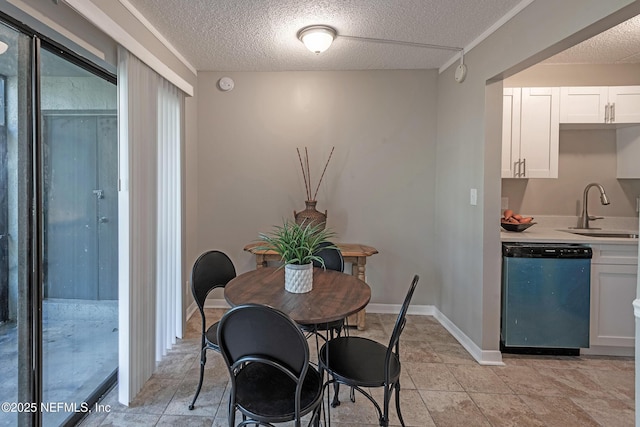 dining room featuring sink and a textured ceiling