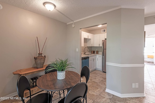 dining area with a textured ceiling and sink