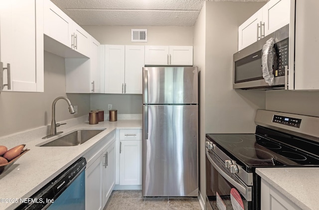 kitchen with white cabinets, appliances with stainless steel finishes, and sink