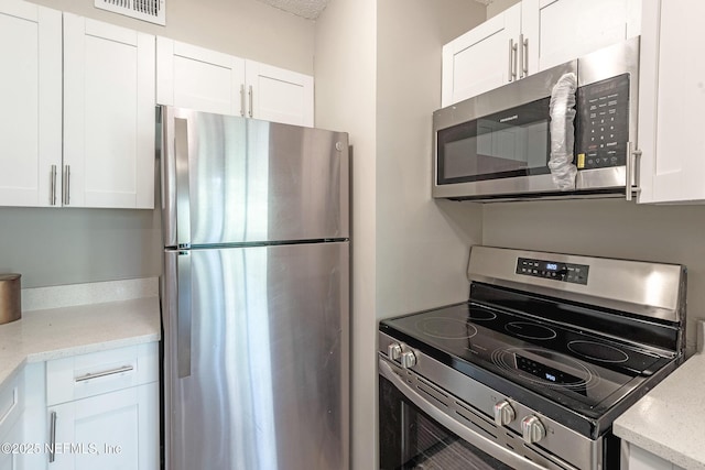 kitchen featuring white cabinetry and stainless steel appliances