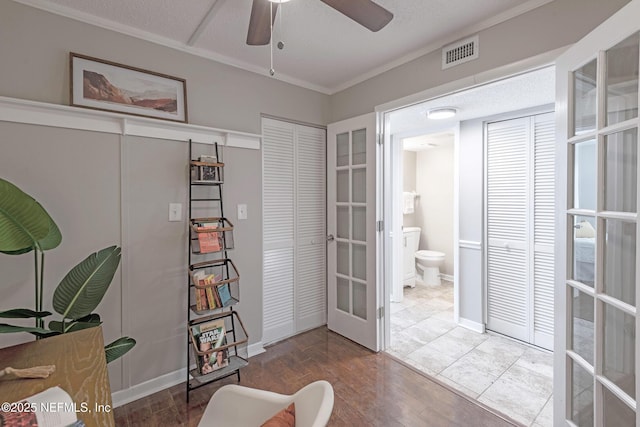 office space featuring ceiling fan, wood-type flooring, ornamental molding, and french doors