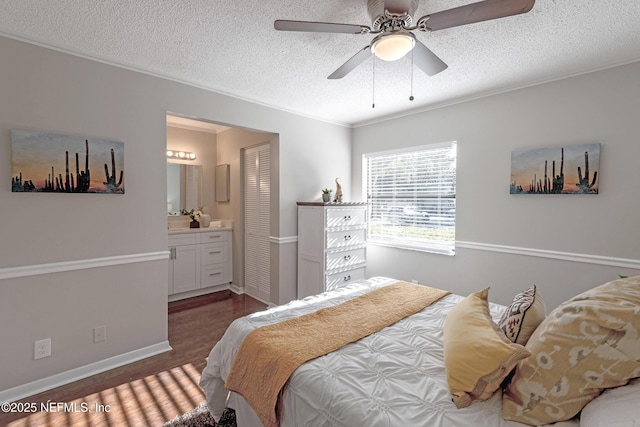 bedroom featuring dark hardwood / wood-style flooring, a textured ceiling, ceiling fan, crown molding, and connected bathroom