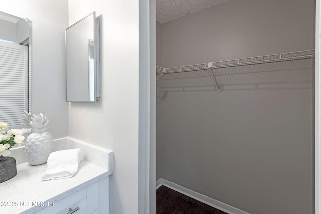 bathroom featuring vanity, a textured ceiling, and hardwood / wood-style flooring