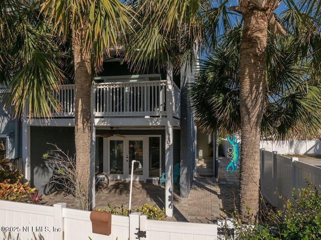 back of property featuring a patio area, french doors, and a balcony