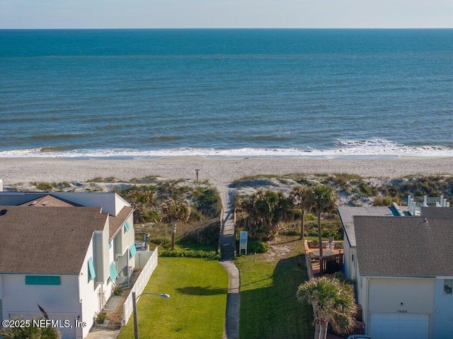 drone / aerial view featuring a water view and a view of the beach