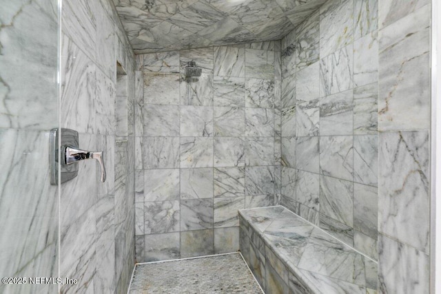 bathroom featuring a tile shower