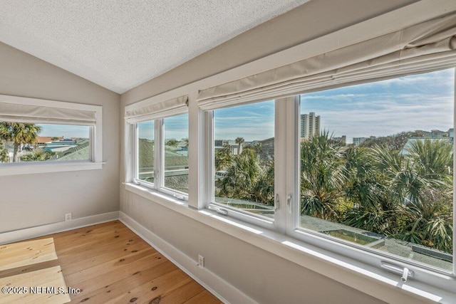 unfurnished sunroom featuring vaulted ceiling