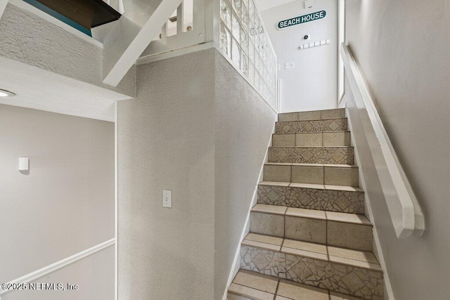 stairway featuring tile patterned floors