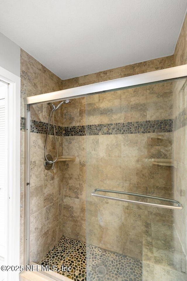 bathroom with a shower with shower door