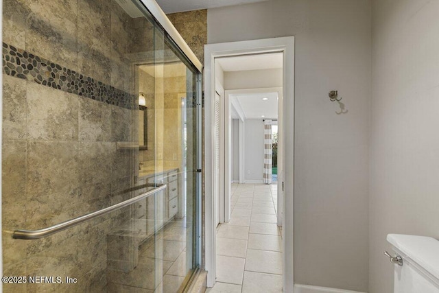 bathroom with walk in shower, tile patterned floors, and toilet