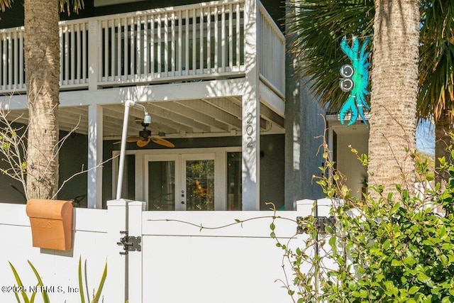 doorway to property featuring a balcony and ceiling fan