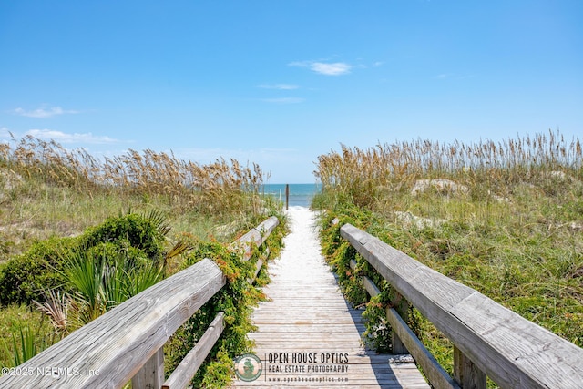 view of property's community featuring a view of the beach and a water view