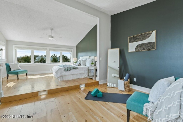 bedroom with lofted ceiling and wood-type flooring