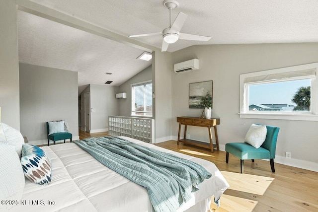 bedroom with vaulted ceiling, wood-type flooring, a wall mounted AC, ceiling fan, and a textured ceiling