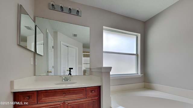 bathroom featuring vanity and a tub