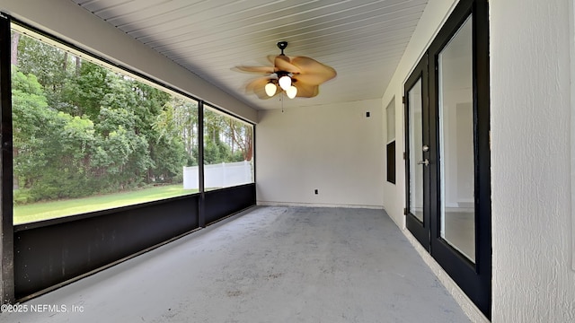 unfurnished sunroom with ceiling fan