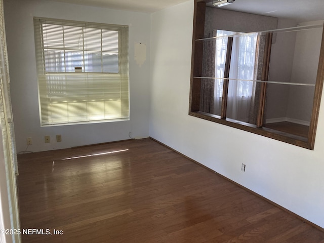 spare room featuring dark wood-type flooring