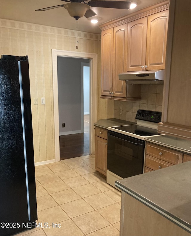 kitchen with ceiling fan, range with electric cooktop, light brown cabinets, black refrigerator, and light tile patterned floors