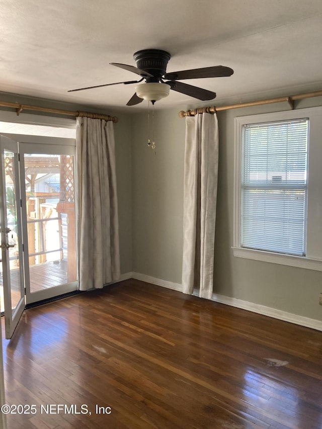 spare room featuring dark hardwood / wood-style floors and ceiling fan