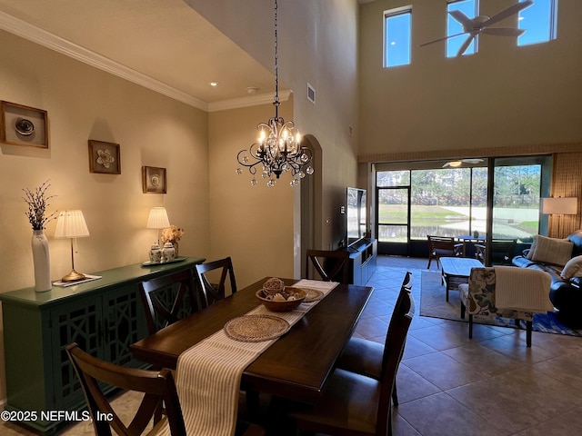 dining room featuring tile patterned flooring, ceiling fan with notable chandelier, and ornamental molding