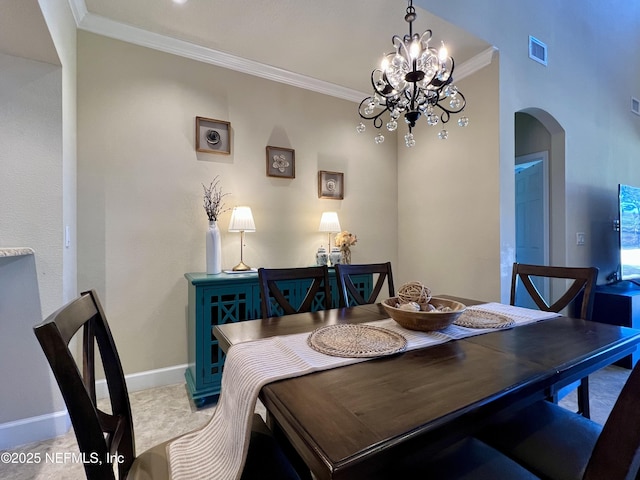 dining space with ornamental molding and a notable chandelier