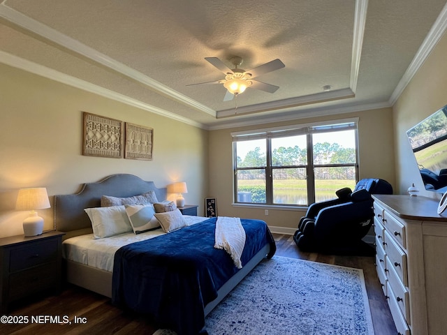 bedroom with a tray ceiling, ceiling fan, and crown molding