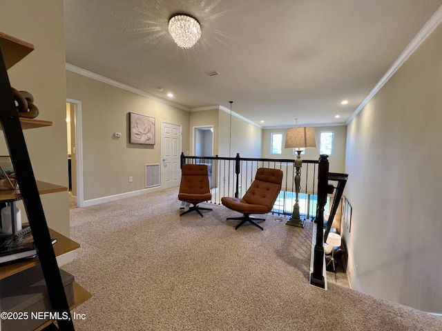 sitting room with carpet, ornamental molding, and an inviting chandelier