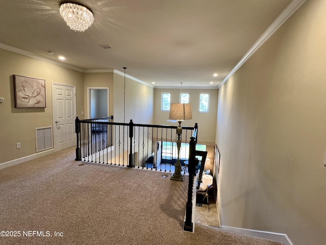 hallway with carpet, a notable chandelier, and ornamental molding