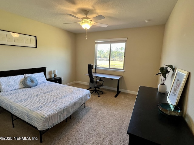 bedroom featuring carpet, ceiling fan, and a textured ceiling