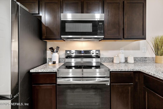 kitchen featuring dark brown cabinetry and appliances with stainless steel finishes