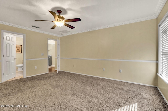 empty room featuring carpet flooring, ceiling fan, and crown molding