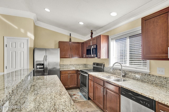 kitchen featuring sink, light stone counters, lofted ceiling, appliances with stainless steel finishes, and ornamental molding