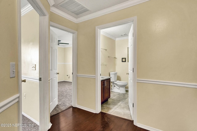 hallway with hardwood / wood-style floors and ornamental molding