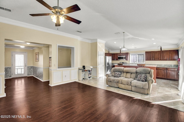 living room featuring light wood-type flooring and ornamental molding