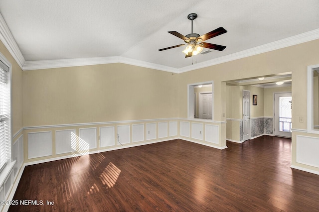 spare room with lofted ceiling, ornamental molding, and dark wood-type flooring