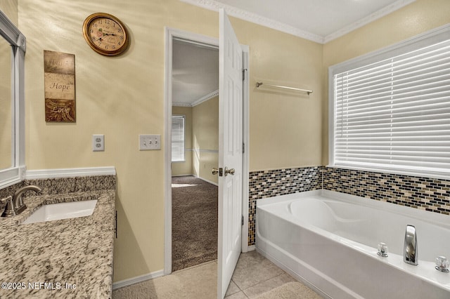 bathroom with tile patterned flooring, vanity, a bathing tub, and crown molding