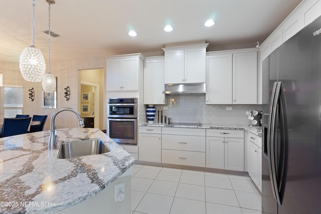 kitchen featuring white cabinets, stainless steel appliances, hanging light fixtures, and sink