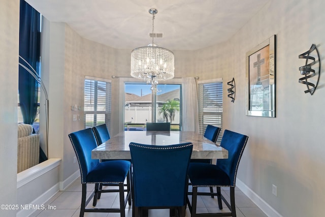 dining area featuring tile patterned flooring and a notable chandelier