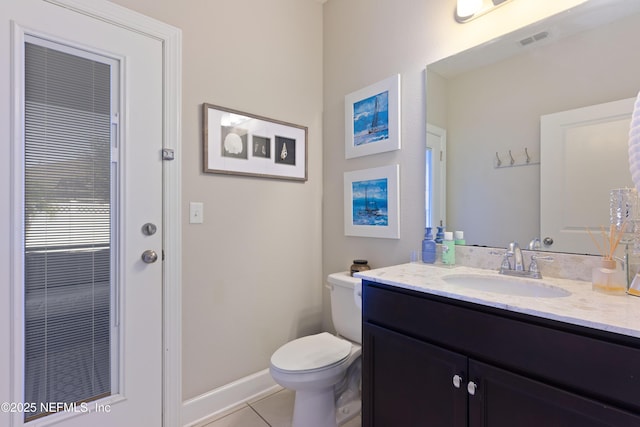 bathroom featuring tile patterned floors, vanity, and toilet