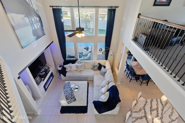 tiled living room with ceiling fan