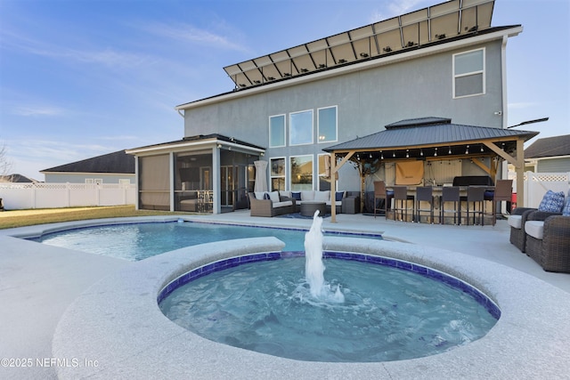 view of swimming pool with outdoor lounge area, a sunroom, an outdoor bar, and a grill