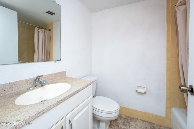 full bathroom with vanity, toilet, and shower / tub combo with curtain