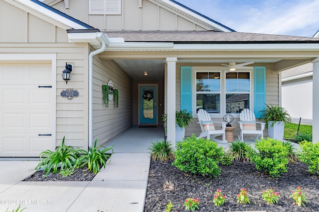 property entrance featuring covered porch, ceiling fan, and a garage