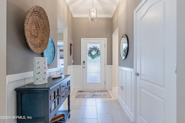 doorway with crown molding, light tile patterned floors, and an inviting chandelier