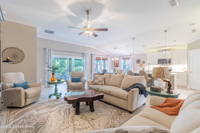 living room with lofted ceiling, sink, ceiling fan, light tile patterned floors, and ornamental molding