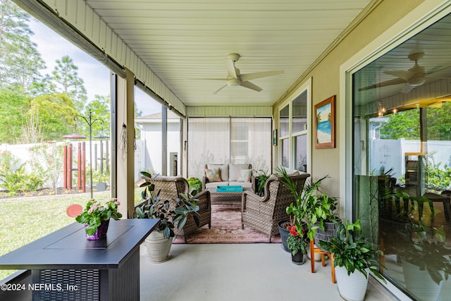 sunroom featuring ceiling fan