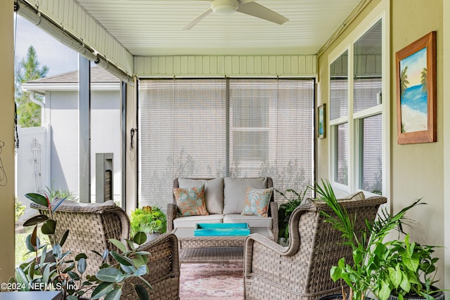 sunroom featuring ceiling fan