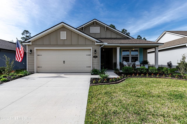 view of front facade featuring a porch, a garage, and a front lawn